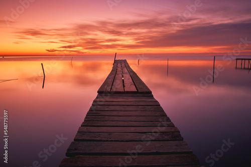 pontoon on the shore of the lake at sunrise