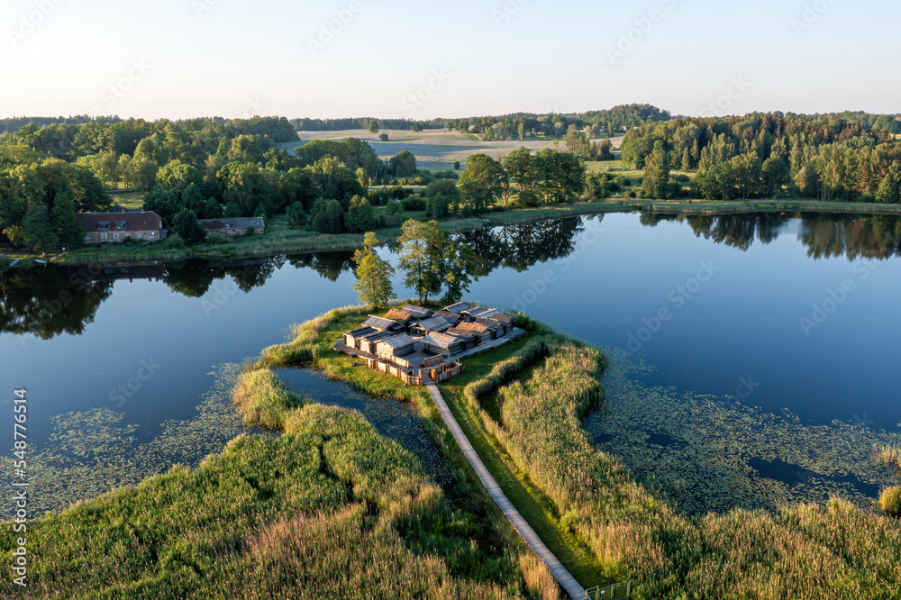 view from above of ancient wooden settlement on river island, recontruction of ancient architecture