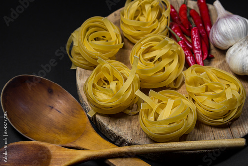 Pasta nests on a black background. traditional italian food