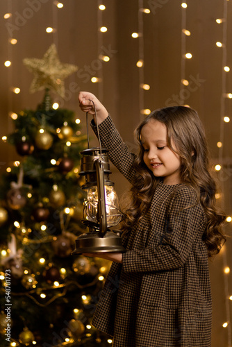 beautiful girl with a Christmas lantern