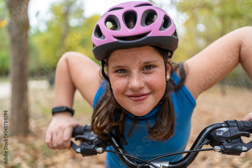 Happy teenage boy leaning on bike handlebar