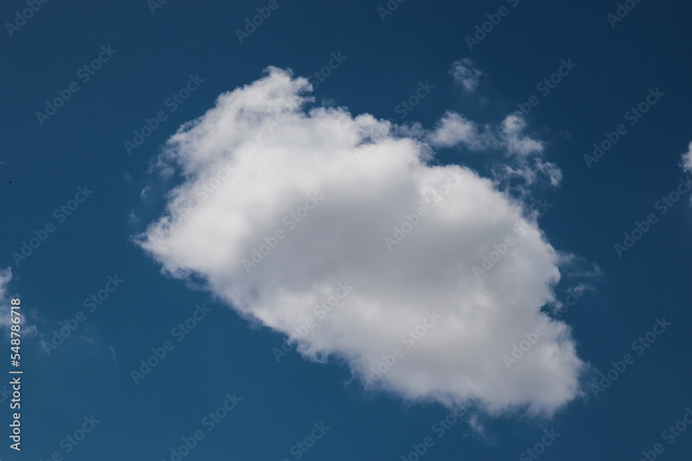 blue sky with clouds A single low floating cloud stands out in the middle of the blue sky contrasting with the white clouds. blue sky with clouds A single low floating cloud stands out in the middle of the blue sky contrasting with the white clouds.