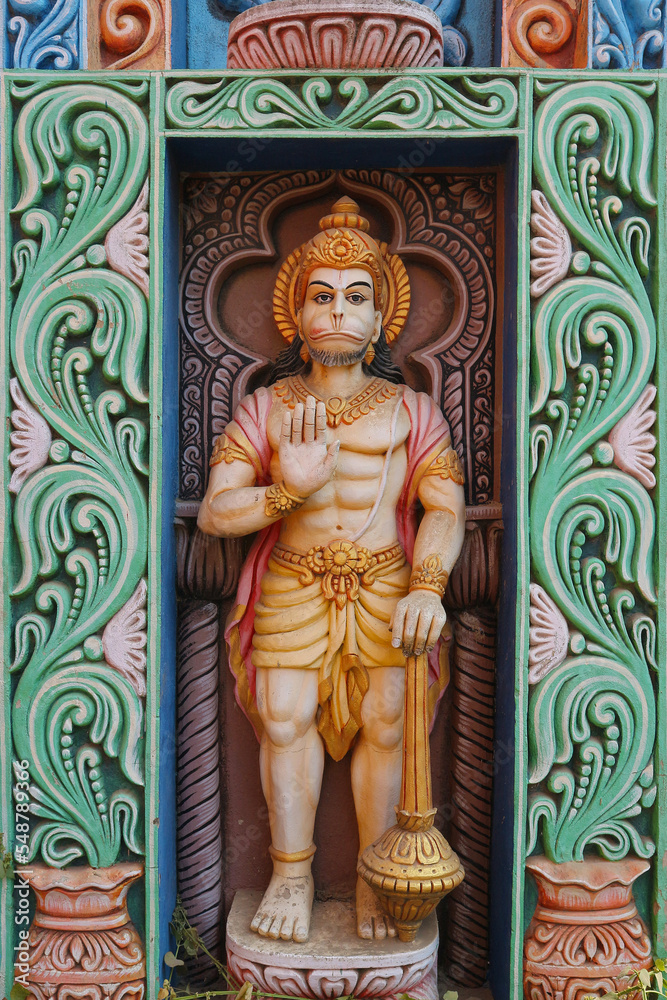 Indian monkey god Hanuman, devotee of Rama. A full-length figure of the hero of the Ramayana on the gate of a temple in Puri, Orissa, India. Vertical photo.