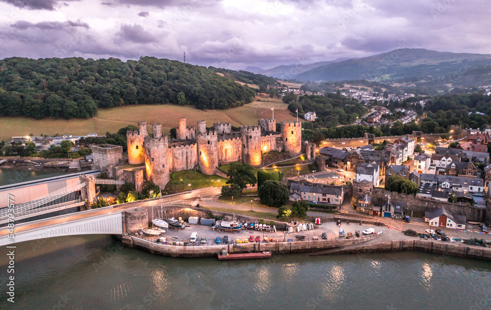 Aerial view with Conwy town and the medieval castle, the famous landmark of Wales and UK, captured at sunset