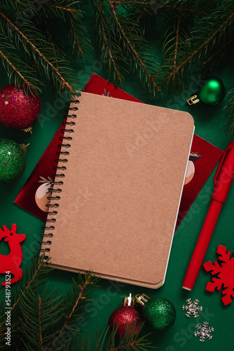 Empthy notebook on a festive Christmas background with decoration and fir tree branches. Copy space. photo