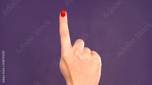 Wallpaper Mural Countdown. Female hand counting 1 on purple background. Girl shows fist fist Torontodigital.ca