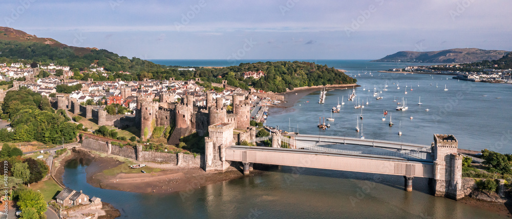 Aerial view with Conwy town and the medieval castle, the famous landmark of Wales and UK, captured in the morning