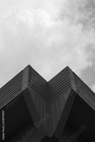 black and white building with clouds