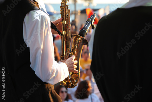 Canvas Print Musician playing saxophone into microphone outdoor concert
