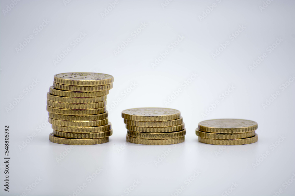 Coins of different monetary value on an unfocused background isolated on white with copy space. inflaction Coins of different monetary value on an unfocused background isolated on white with copy space. inflaction