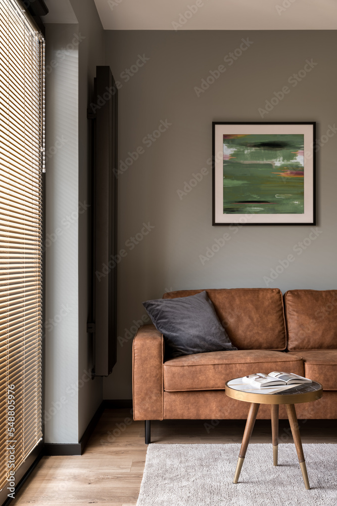 Fototapeta premium Brown couch in living room with big window