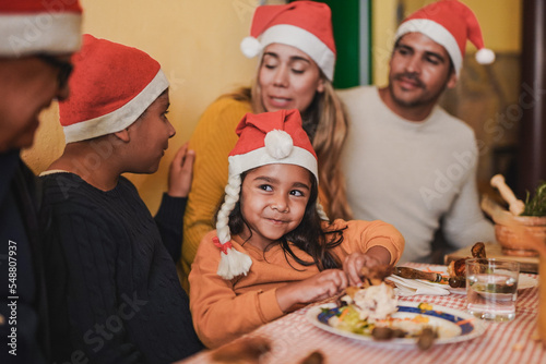 Happy latin family celebrating christmas eve together - Multi generational people eating dinner at home
