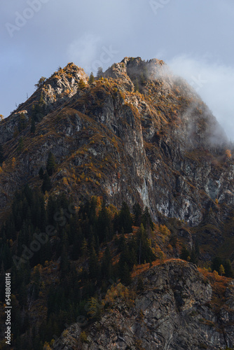 Autumn colors during the early morning, between the mountains and woods of the Antrona valley, near the town of Antronapiana, Italy - October 2022. photo