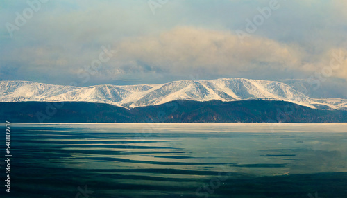 Stunning lake baikal in winter snowy mountain with cloudy sky