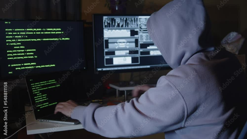 Young hacker, working and hacking with his computers. Attacking systems and danger computering. Young hacker, working and hacking with his computers. Attacking systems and danger computering.