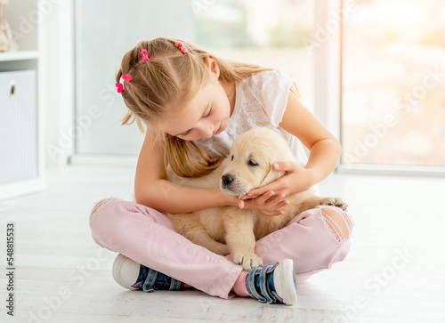 Lovely girl looking at puppy