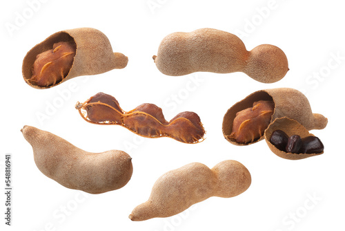 Tamarind pods (Tamarindus indica fruits): whole, cracked, seeds and pulp, isolated photo