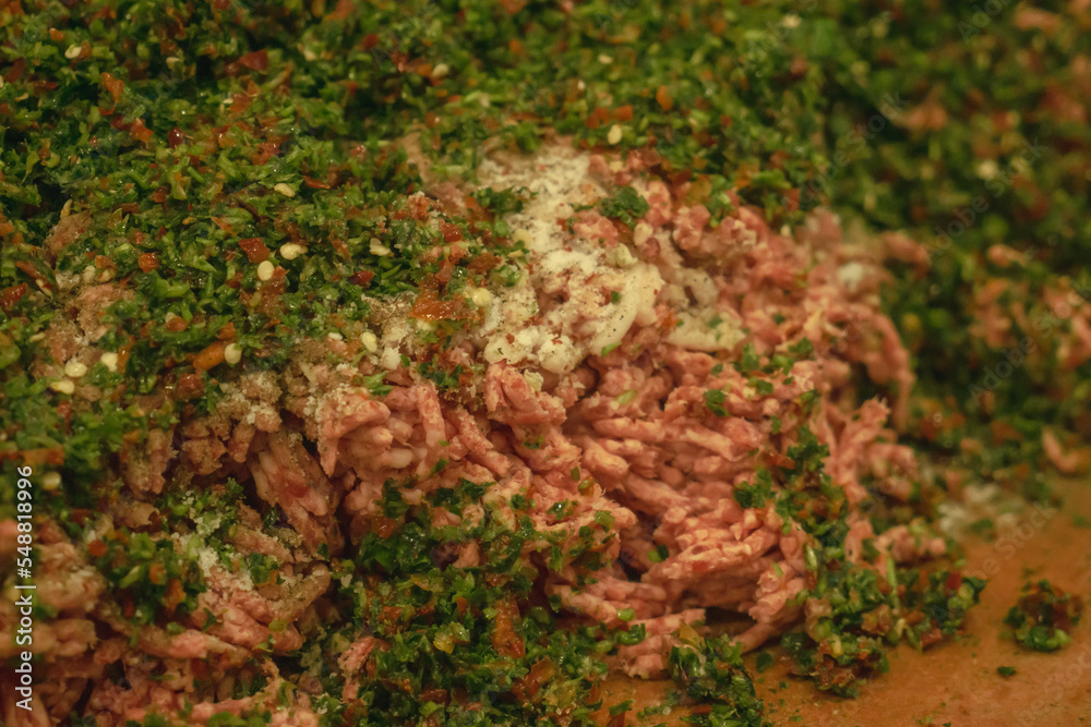 Mixing Minced meat with herbs and spices Mixing Minced meat with herbs and spices