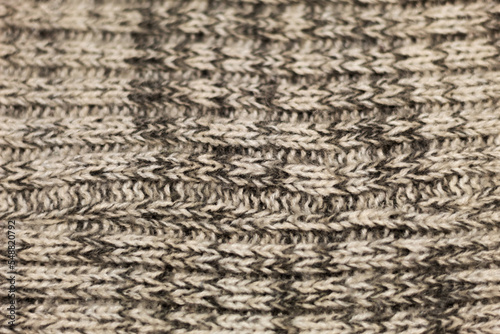 Close up on a cozy and warm fabric of a beige winter sweater