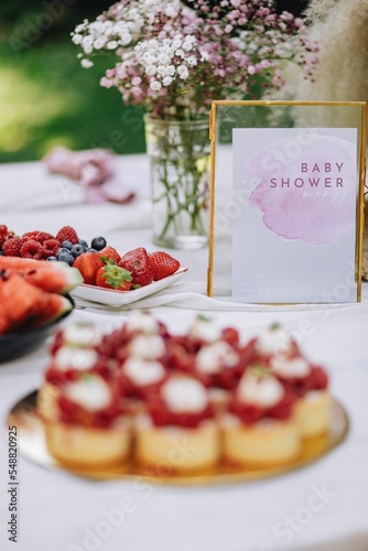 Vertical shot of a dessert with raspberries at a baby shower party.