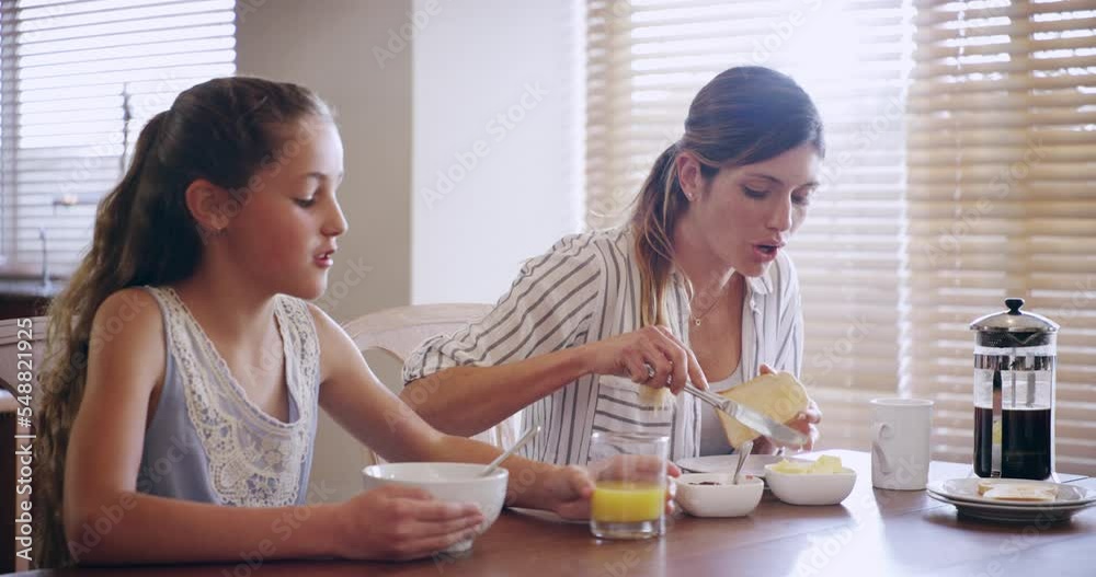 Bread, mother and girl eating breakfast and drinking orange juice in the morning as a happy family at home together. Love, mom and happy female child teenager enjoying healthy brunch food at a table Bread, mother and girl eating breakfast and drinking orange juice in the morning as a happy family at home together. Love, mom and happy female child teenager enjoying healthy brunch food at a table