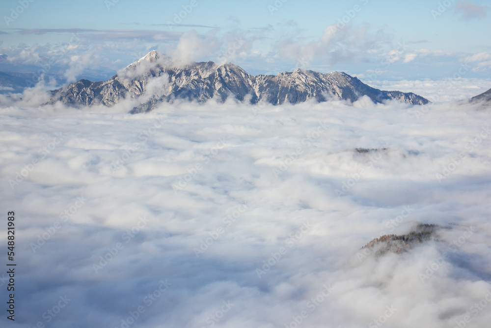 Julian Alps Slovenia, peak Debela Pec 2014 m, winter hiking in Triglav with snowy peaks and mist Julian Alps Slovenia, peak Debela Pec 2014 m, winter hiking in Triglav with snowy peaks and mist