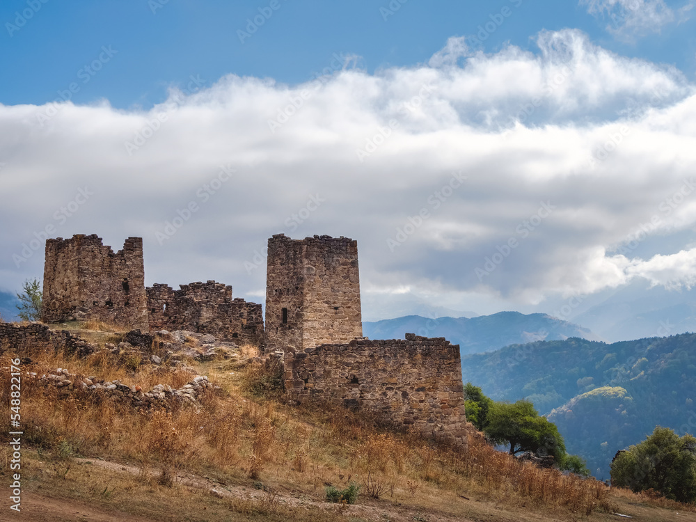 Majestic ancient tower buildings of Kelly in the Assinesky Gorge of mountainous Ingushetia, one of the medieval castle-type tower villages, located on the extremity of the mountain range, Russia.