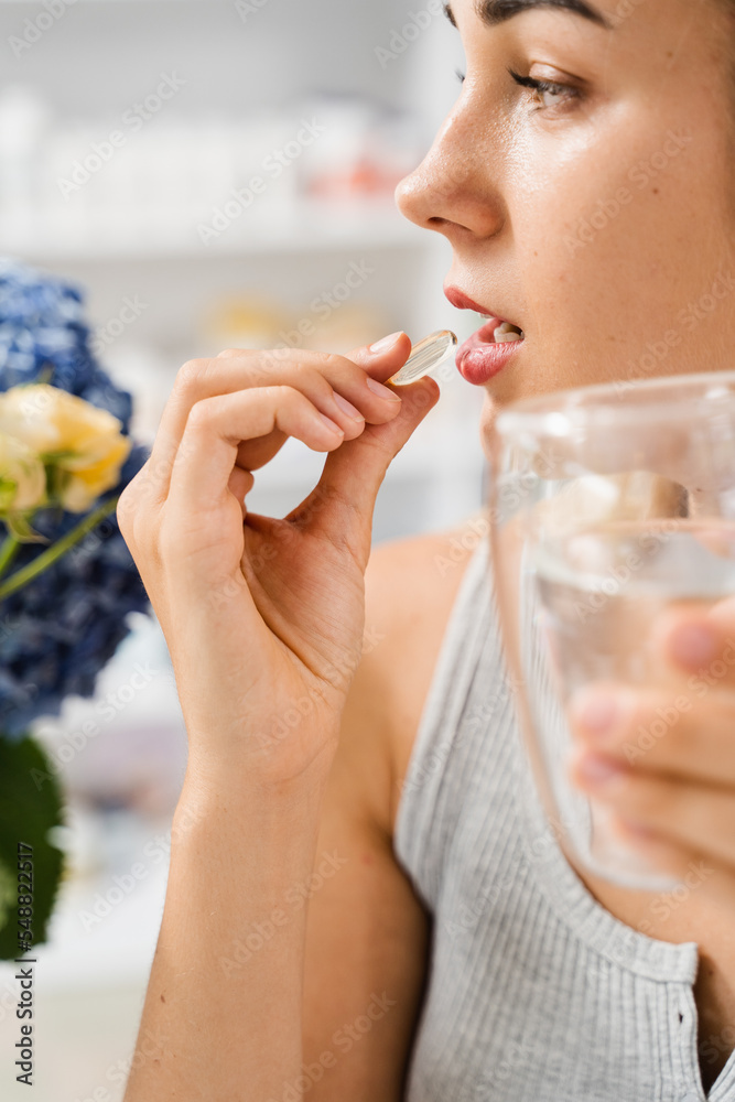 Girl is taking capsule of collagen supplement. Collagen pills to support skin health. BADS biologically active dietary supplements for healthcare. Girl is taking capsule of collagen supplement. Collagen pills to support skin health. BADS biologically active dietary supplements for healthcare.