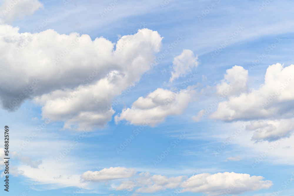 Fototapeta premium White clouds in a bright blue sky. The beauty of the nature
