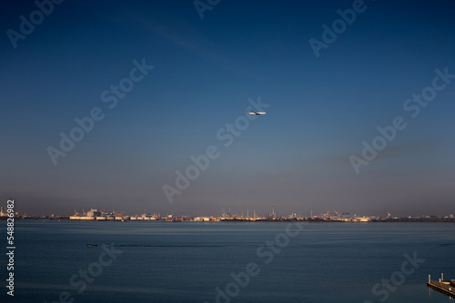 Landing plane and passing ship in Venice.