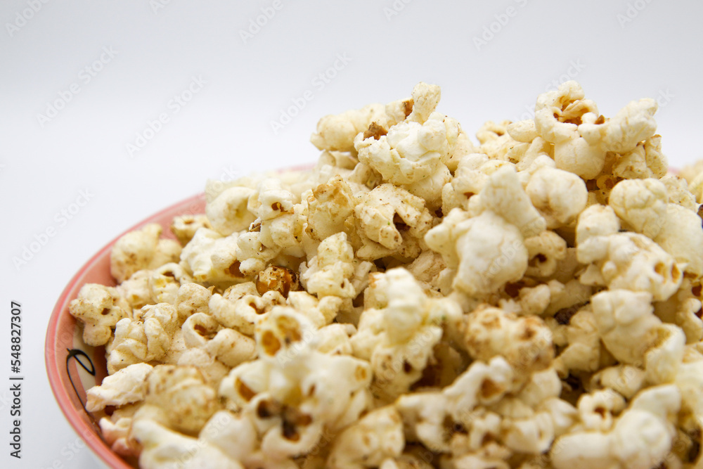 Popcorn on a plate on a white background