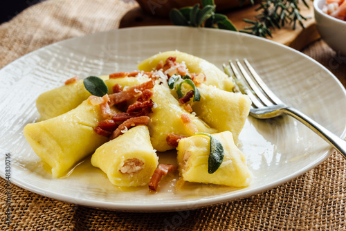 Stuffed gnocchi seasoned with melted butter, sage and strips of speck