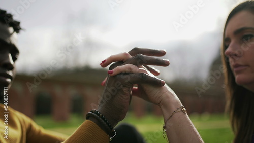 Black man and white woman hands uniting together, diversity concept