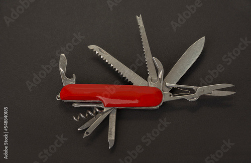 Open swiss army knife on a black background photo