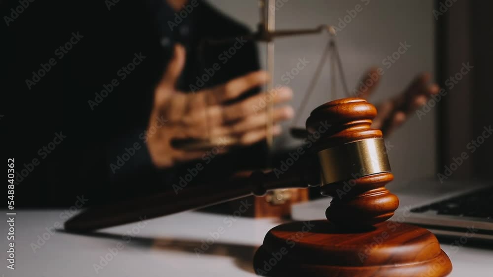 Business and lawyers discussing contract papers with brass scale on desk in office. Law, legal services, advice, justice and law concept picture with film grain effect Business and lawyers discussing contract papers with brass scale on desk in office. Law, legal services, advice, justice and law concept picture with film grain effect