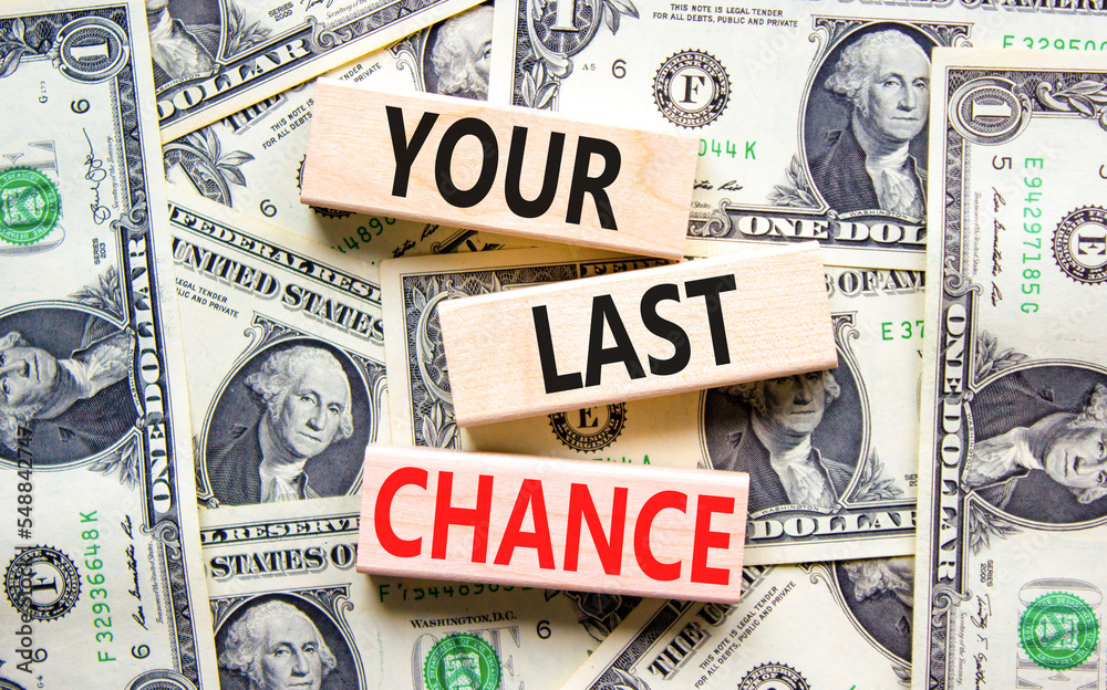 Time to your last chance symbol. Concept words Your last chance on wooden blocks on a beautiful background from dollar bills. Business and your last chance concept. Copy space.