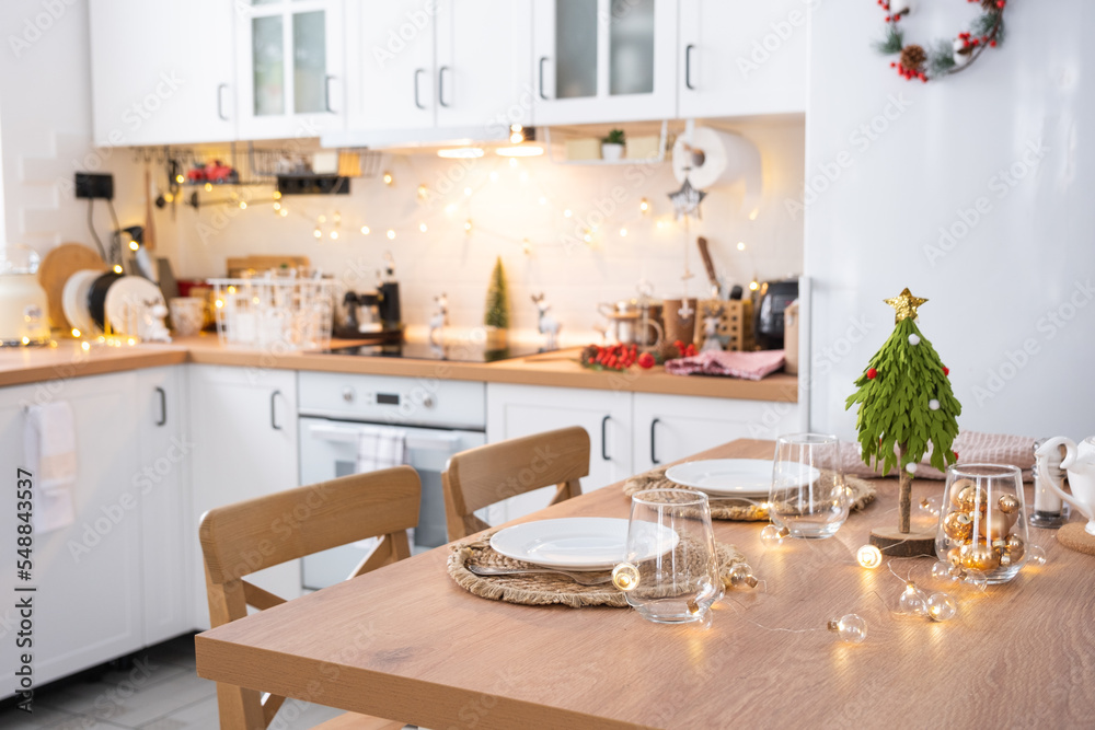 Festive Christmas decor and mess in the light kitchen, festive breakfast, white scandi interior. New Year, mood, cozy home 