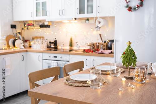Festive Christmas decor and mess in the light kitchen, festive breakfast, white scandi interior. New Year, mood, cozy home 