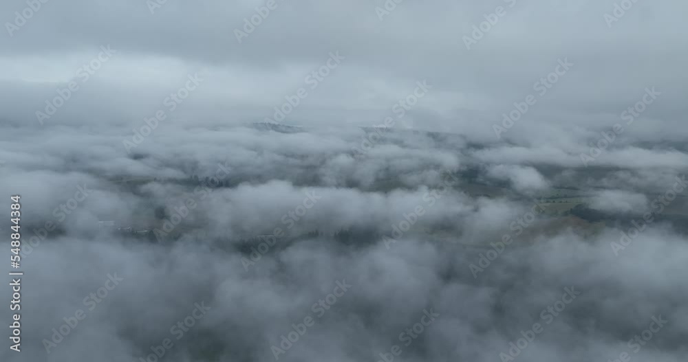 Rainy weather in mountains. Misty fog blowing over pine tree forest. Aerial footage of spruce forest trees on the mountain hills at misty day. Abstract copy space natural background. Rainy weather in mountains. Misty fog blowing over pine tree forest. Aerial footage of spruce forest trees on the mountain hills at misty day. Abstract copy space natural background.