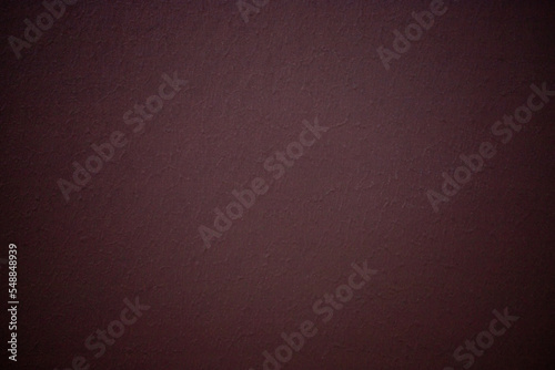 Dark burgundy color abstract wall textured background with vignette
