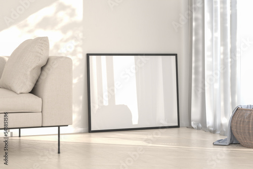 Interior mockup - Living room with sofa and wicker basket. One blank picture frame leaning to the wall. photo
