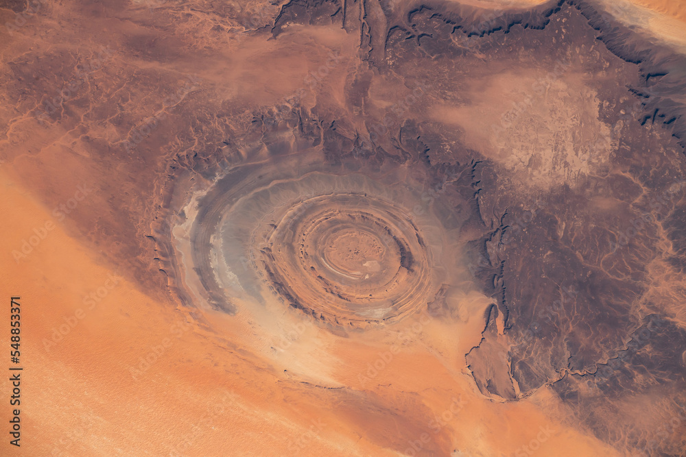 Aerial view of Richat Structure in Mauritania. Also called Guelb er Richât in Arabic Qalb ar-Rīšāt.  Digitally enhanced. The elements of this image furnished by NASA. - obrazy, fototapety, plakaty 