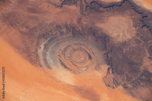 Aerial view of Richat Structure in Mauritania. Also called Guelb er Richât in Arabic Qalb ar-Rīšāt.  Digitally enhanced. The elements of this image furnished by NASA.