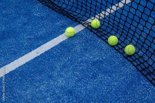 selective focus, four balls at the net on a paddle tennis court. Racket sports © VicVaz