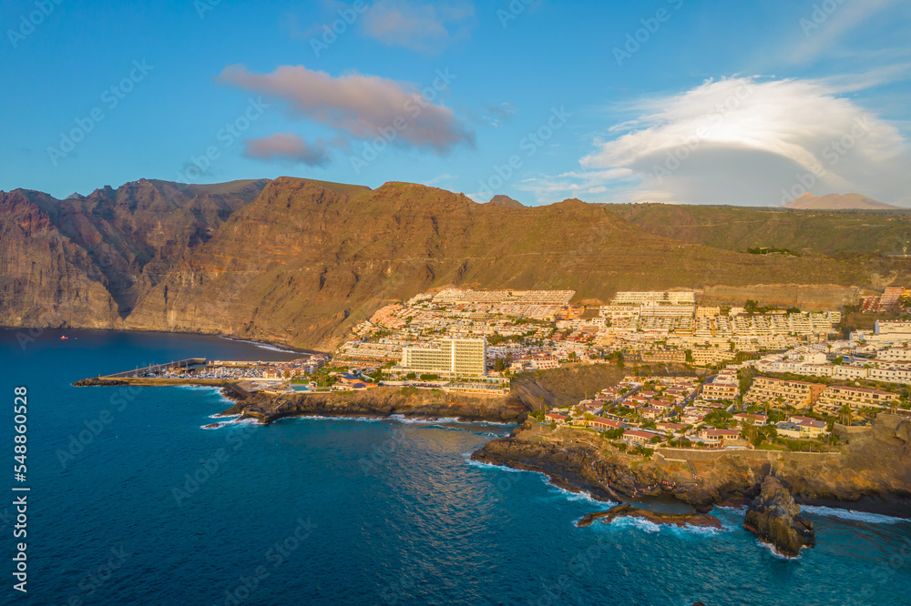 Aerial drone photo of Puerto Santiago and Los Gigantes, Tenerife, Canary Islands. Coastline with cliffs and ocean photo during a sunset