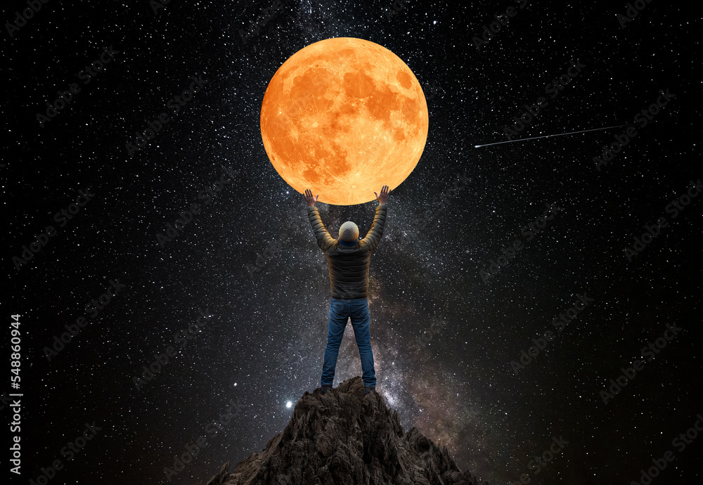 Man On Top Of The Mountain Tried To Touch The Full Moon Stock Photo man-on-top-of-the-mountain-tried-to-touch-the-full-moon-stock-photo