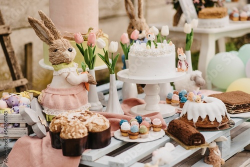 Closeup of a beautifully decorated Easter cake and other sweets on a table