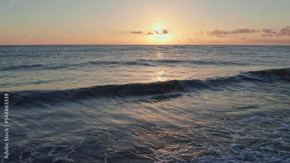 Foaming waves at sunrise on a paradise beach. Foaming waves at sunrise on a paradise beach.