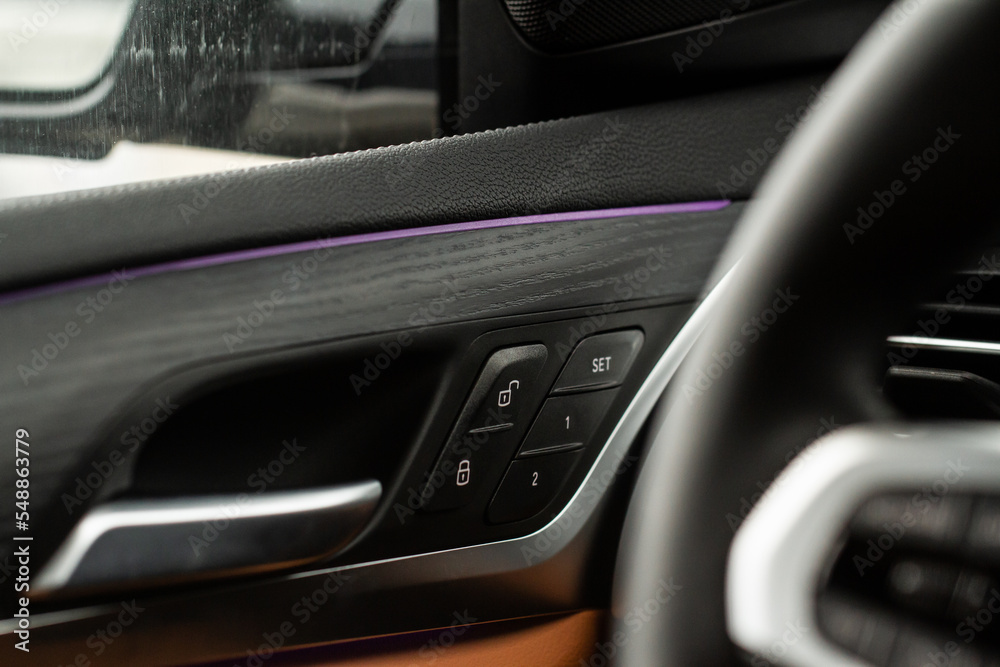 Car door lock unlock button close up. Modern car door lock. Door control panel in a new car. Car door lock unlock button close up. Modern car door lock. Door control panel in a new car.