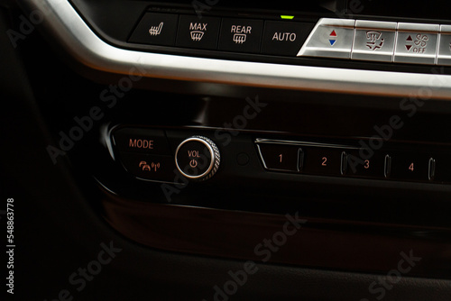Volume button in car panel. Control panel of audio player. Sound control button. © Roman